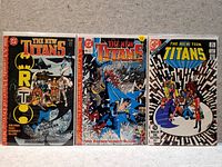 Photo shows three comic books from The New Titans series side by side, arranged upright with covers visible.