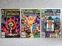 Three Fantastic Four comic books laid side-by-side showing front covers.
