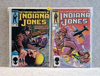 Photo of two Indiana Jones comics: issue #28 and issue #30, showing vibrant action scenes and classic comic book art.