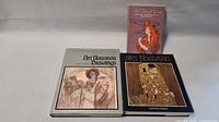 Photo of the three Art Nouveau books including two hardcover coffee table books and one smaller softcover book, showing front covers.