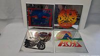 Four square mirrored art pieces including Pink Floyd, AC/DC, Budweiser and Harley Davidson shown together