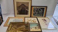 Full lot display of all seven framed artwork and photo items showing various subjects including native art, young woman portrait, train station and landscapes. Frames of various sizes and materials.