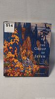 Front cover of the hardcover book showing colorful autumn foliage and the title 'The Group of Seven and Tom Thomson'