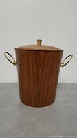 Front view of teak wood ice bucket with lid, brass handles visible