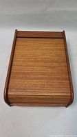Top view of the teak wood cassette storage box with the roll-back cover fully closed, showing the slatted wood design.