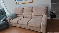 Side view of neutral color 3 seat sofa with corduroy fabric upholstery and attached note regarding lot and mattress count