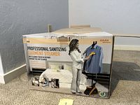 Original retail box showing brand and usage image of professional sanitizing garment steamer
