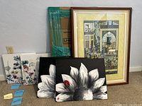 Five pieces of wall art including four canvases with floral designs and one framed print.
