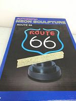 Box top showing printed image of neon sculpture and labeling