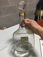 Front angle showing the etched Jack Daniel's Old No. 7 logo on the clear glass bottle with stopper in place.