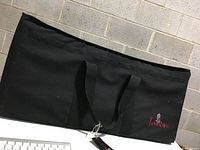 Front view of the black Talon nylon soft carrying case showing the double handles and logo.