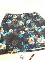 Full view of the 2XL floral skort showing black fabric with blue and floral print, elastic waist and drawstring