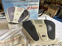 Full view of the Electro Reflex Energizer SW-2000 device with original box and user manual on white background.