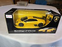 Yellow Lamborghini Murcielago LP 670-4 SV 1/24 scale remote control car in original sealed black Rastar box with clear display window.