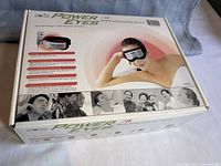 Photo of the Soqi Power Eyes box showing branding, model, and a person using the device