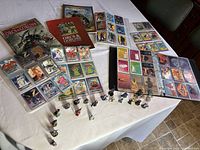 Warhammer Orcs & Goblins books, metal miniatures, and trading card binder displayed on table