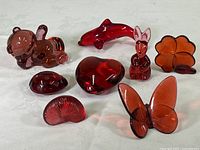 Overview of all eight ruby/cranberry colored glass decor pieces