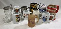 Photo showing entire collection of 11 mugs and glassware items in a row