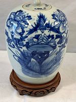 Front view of jar on stand highlighting overall shape and painted decoration