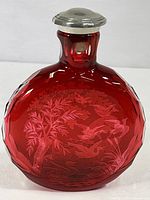 Front view of crimson crystal bottle with stopper in place