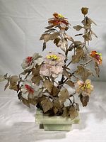 Front view of vintage Chinese jade tree sculpture showing carved pink and orange stone flowers with metal leaves and green stone base.