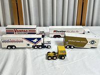 Five diecast transport trucks displayed together showing overall size, scale, and condition