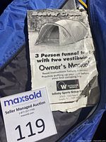 Close-up of the Beaver Creek owner's manual on top of the blue and gray tent storage bag.
