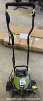 Front view of Radley electric rotary tiller on concrete floor with tagging sticker 175 visible
