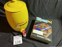 Yellow ceramic lemonade dispenser and boxed LED inflatable buffet tray with colorful LED lights on the box.