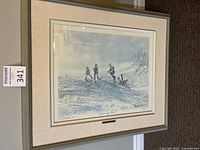 Framed hockey print featuring three children playing on a hill covered with snow. Signed by G. Grunfelder.