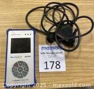 Blue-Point EECR3 handheld OBD-II scanner with attached cable on wooden surface, front view showing screen and button layout.