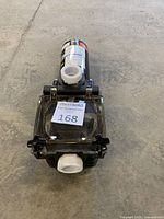 Top view showing clear strainer lid and inlet and outlet fittings