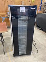 Front view of wine cooler with glass door and stainless steel handle