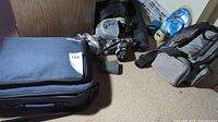Canon camera bags and cameras with lenses and tripod around them