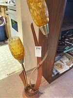 Overall view of lamp showing two amber glass shades, metal stems, and wood base