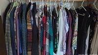 Hanger rack with various blouses, cardigans, and jackets showing different patterns, colors and fabrics