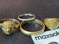 Group shot of four rings on black background