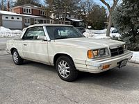Front passenger-side three-quarter view showing front bumper scuffs and body panel fit