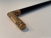 Close-up of the L-shaped gold-filled handle with intricate scrollwork and engraving.