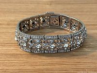 Front angled view of bracelet showing rhinestone-adorned sterling silver openwork panels.