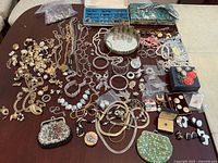 Overhead view of full lot on table, showing necklaces, earrings, bracelets, boxes and accessories