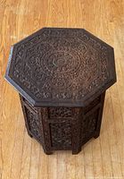 Top down view showing octagonal top with detailed floral and geometric carvings.