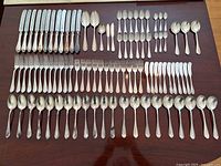 Full overhead view showing all silver pieces arranged in rows