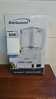 Front view of the Brentwood food processor unopened box showing product image and maxsold tag