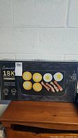 Box of Continental 18K Signature Series 20-inch electric griddle featuring a photo of the griddle surface with eggs and bacon cooked on it.
