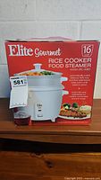 Front view of the boxed Elite Gourmet 16 cup rice cooker and food steamer.