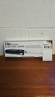 Front view of the unopened Elite Cuisine Electric Knife box highlighting the product image and branding.