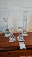 Full set of four crystal candlesticks: pair of 7-inch Waterford candlesticks (center), one 10-inch (left) and one 12-inch (right) candlesticks