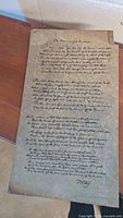 Full view of the handwritten Star Spangled Banner on aged paper showing entire text and condition including a tear at the top right corner.