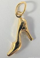 Close-up of the front side of the 10K yellow gold high heel shoe pendant showing the smooth polished surface and shoe details.
